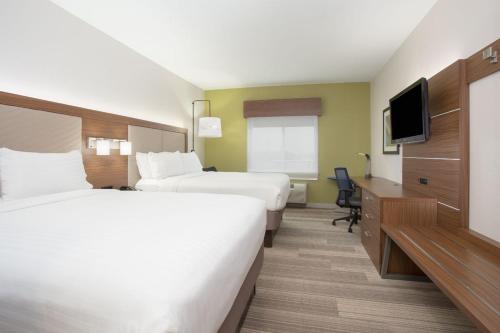 a hotel room with two beds and a flat screen tv at Holiday Inn Express & Suites Amarillo by IHG in Amarillo
