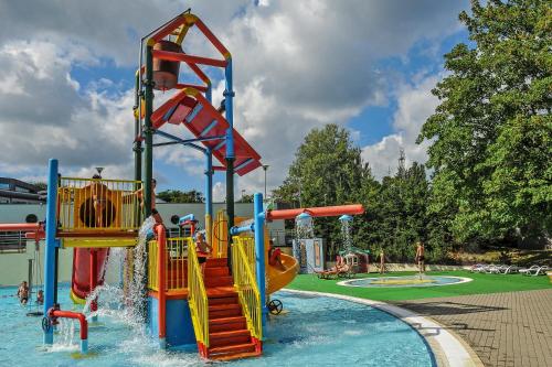 a water park with a water slide in the water at Traper Apartamenty in Sopot