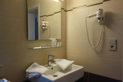 a bathroom with a sink and a shower at La Clochette in Celles