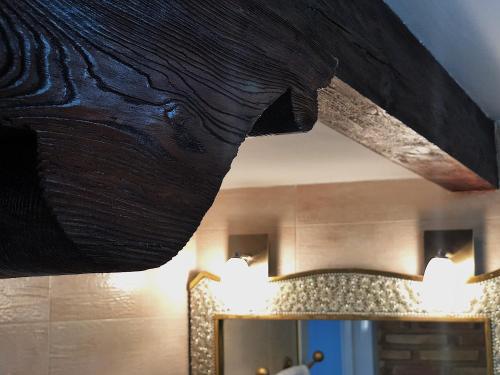 a wooden ceiling in a room with a mirror at Retiro del Teatro Almagro in Almagro