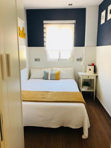 a bedroom with a large bed with a window at Luxury Playamar Beach in Torremolinos