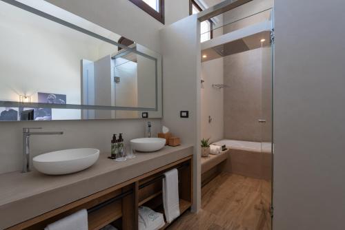 a bathroom with two sinks and a tub at Momentum Wellness Bioresort in Marinella di Selinunte