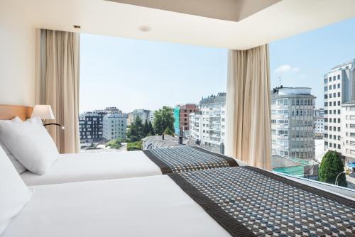 a hotel room with a bed and a large window at Exe Puerta San Pedro in Lugo