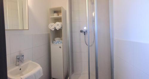 a bathroom with a shower and a sink at Mariazeller Rooms in Mariazell