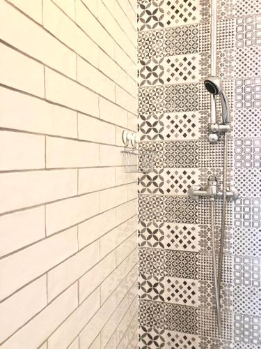 a bathroom with a shower with white tiles at Seaview Apartment in Koper
