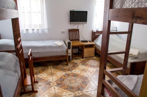 a room with two bunk beds and a television at Home Hotel in Kamianets-Podilskyi