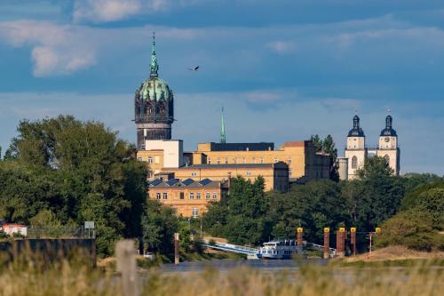 a large building with two domes on top of it at ALTE SCHULE WITTENBERG, 3 Ferienwohnungen für bis zu 12 Personen, an der Elbe, mit Garten in Lutherstadt Wittenberg