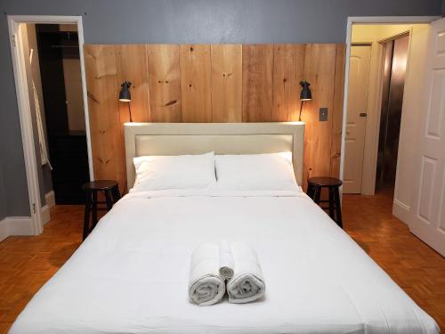 a bedroom with a white bed with two towels on it at Blue Penthouse in the City in Atlanta
