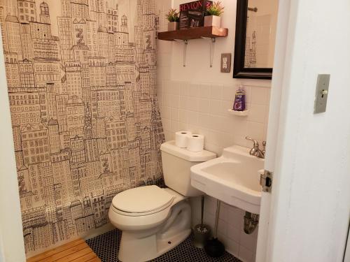 a bathroom with a toilet and a sink at Blue Penthouse in the City in Atlanta
