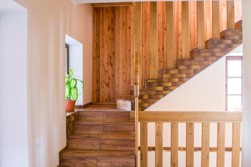 a staircase in a house with wooden floors at Home Hotel in Kamianets-Podilskyi