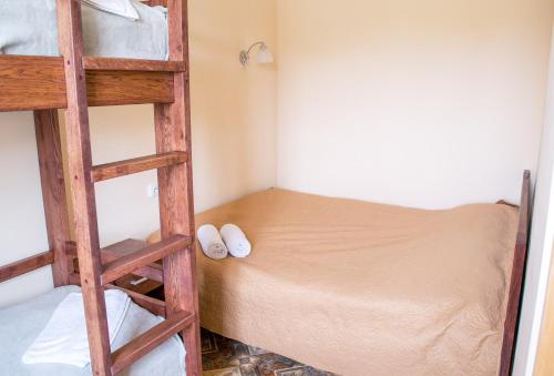 a bedroom with a bunk bed and a ladder at Home Hotel in Kamianets-Podilskyi