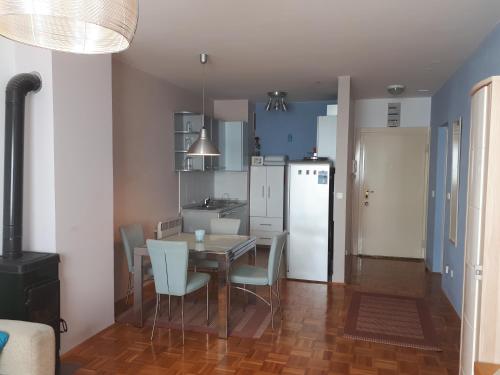 a kitchen and dining room with a table and chairs at Apartment Hana in Crikvenica