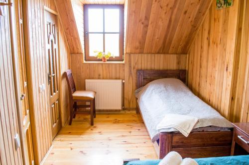 a small bedroom with a bed and a window at Home Hotel in Kamianets-Podilskyi