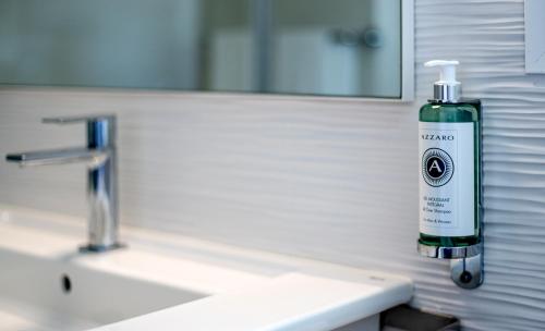 a bottle of mouthwash sitting on a bathroom sink at Villa RG Boutique Hotel - Adults Only in Playa del Ingles