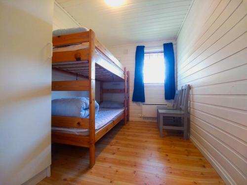 a small room with bunk beds in a house at Sjøholt Camping in Sjøholt