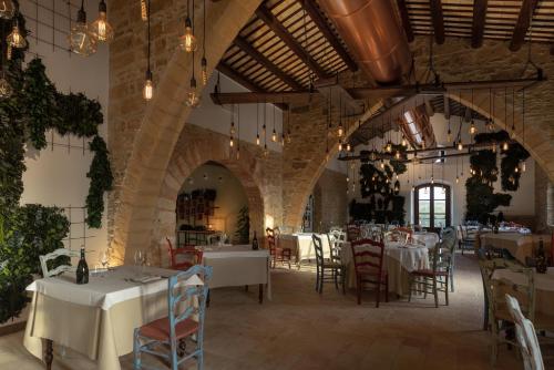 a dining room with tables and chairs in a building at Momentum Wellness Bioresort in Marinella di Selinunte