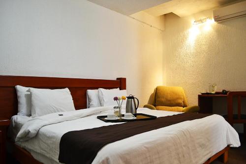 Postel nebo postele na pokoji v ubytování Hotel Campestre Inn