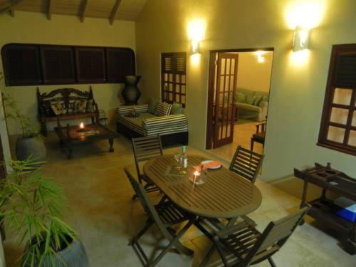 a living room with a table and chairs and a couch at Villa Touloulou in English Harbour Town