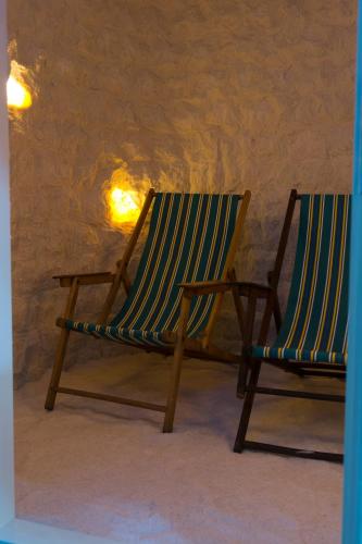 two chairs sitting next to each other in a room at Penzion Signum Laudis in Velké Hamry