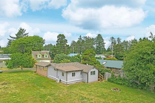 a small house in a yard with a fence at Crabbin Cabin - You Won't Be Crabby After Staying Here! in Westport