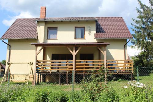 a house with a fence in front of it at Wypoczynek Kocia Góra in Dziemiany