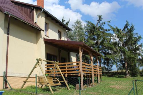 a house with a porch on the side of it at Wypoczynek Kocia Góra in Dziemiany