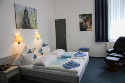 a bedroom with a bed with towels on it at Landgasthaus Bonn in Baunatal