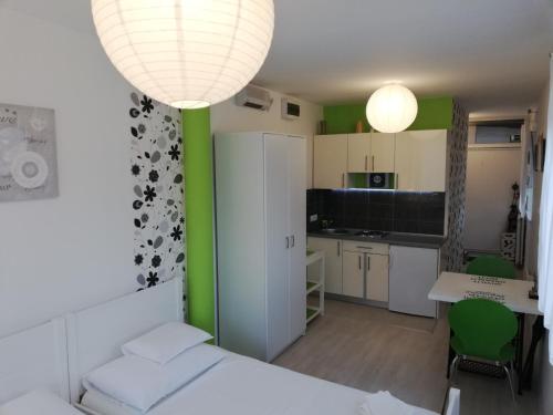 a bedroom with a bed and a table and a kitchen at Apartments Krapinske Toplice Krtak Biba in Krapinske Toplice