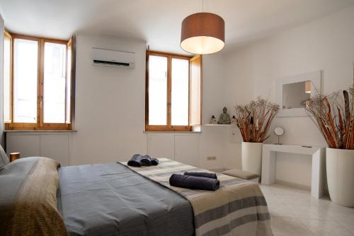 a bedroom with a bed with two towels on it at La Casa nel Corso in Cagliari
