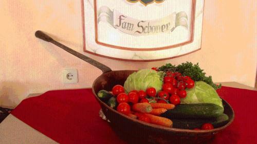 a bowl of vegetables sitting on a table at Landgasthof Dorferwirt in Oberau