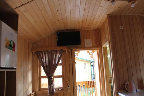 a room with a tv on a ceiling with a window at Villa Edemi in Tskaltubo