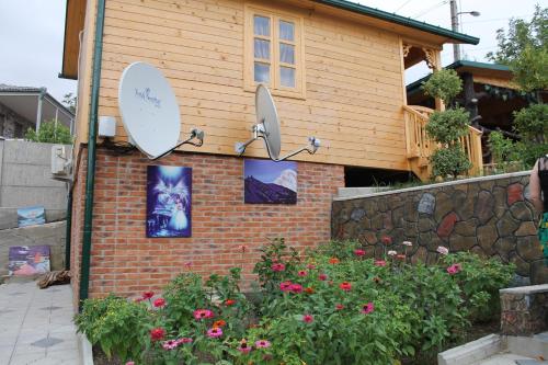a house with a satellite on the side of it at Villa Edemi in Tskaltubo