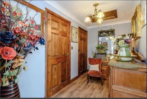 a kitchen with a vase on a counter and a table at Little Croft in Haddenham