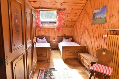 a small room with two beds and a window at Ferienwohnung Waldheimat in Bayerisch Eisenstein