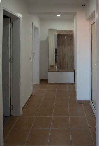 a hallway with a tiled floor in a building at Family Apartments in Zaječar