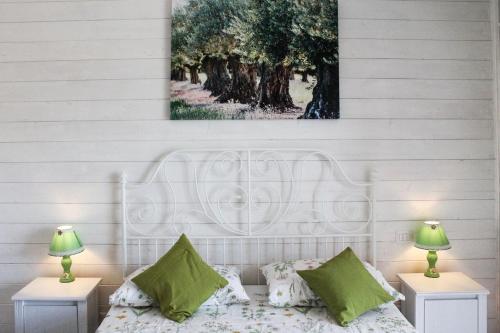 a bedroom with a white bed with two night stands at Il Profumo della Natura B&B in Oriolo Romano
