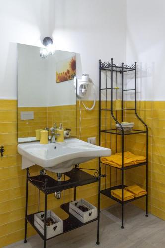 a bathroom with a sink and a mirror at Il Profumo della Natura B&B in Oriolo Romano