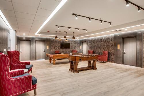 a gaming room with a pool table and a tv at Etage Executive Living in Pittsburgh