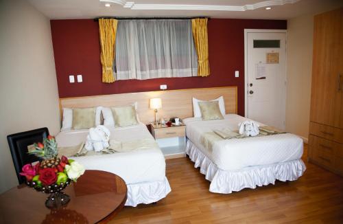 Säng eller sängar i ett rum på Kuna Hotel