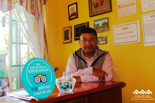 a man sitting at a bar in a restaurant at Casa de Luis in Otavalo