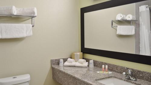 a bathroom with a sink and a mirror at America's Best Value Inn - Memphis Airport in Memphis