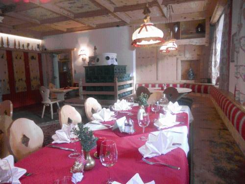 a dining room with a table with a red table cloth at Landgasthof Dorferwirt in Oberau