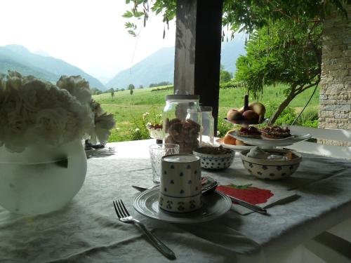 a table topped with plates and bowls of food on a table at La Pâquerette in La Salle