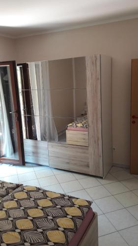 a mirror in a room with a bed in it at Apartment Smajlovic in Kukci