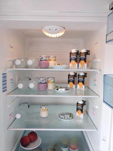 an open refrigerator filled with food and food items at My Sweet Rome Guest House in Rome