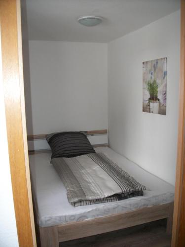 a small bed in a corner of a room at Haus Alpenrose in Schwangau