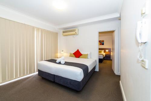 a bedroom with a bed in a hotel room at Amazing Accommodations: St Kilda in Melbourne