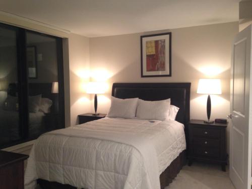 a bedroom with a large bed with two lamps at National at Virginia Square in Arlington