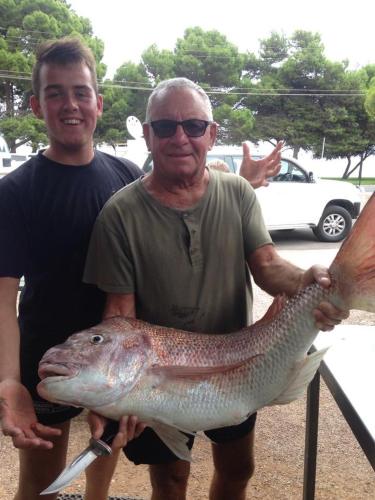 a man holding a large fish in his hands at Ceduna Foreshore Caravan Park in Ceduna