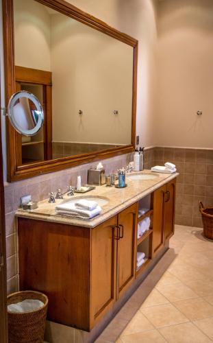 a bathroom with a sink and a large mirror at Blanket Bay in Glenorchy